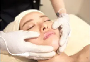 特殊グローブで顔を施術している女性